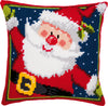 Cross-stitched pillow with a festive design of Santa Claus on a blue background.