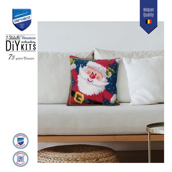 Decorative pillow with Santa Claus design on a white couch, featuring Vervaco branding.