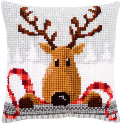 Cross-stitched pillow with a reindeer design on a white background