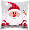 Cross-stitched Santa Claus design on a pillow with a reindeer in the background.