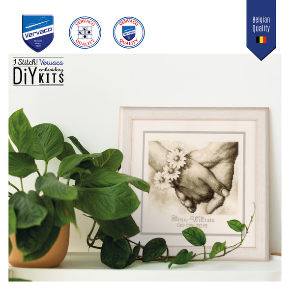 Framed artwork with a plant on a white surface, featuring Vervaco embroidery kit branding.