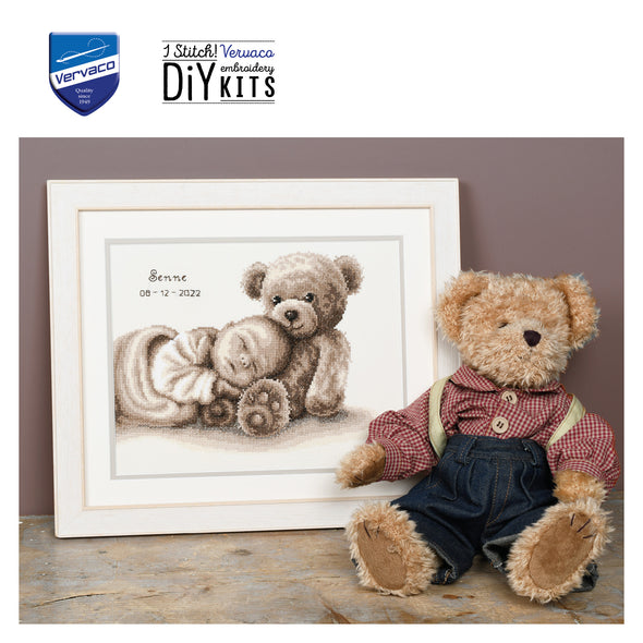 Teddy bear with a framed embroidery design and Vervaco logo.